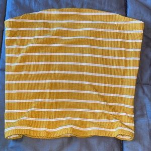 Mustard yellow sleeveless crop top.